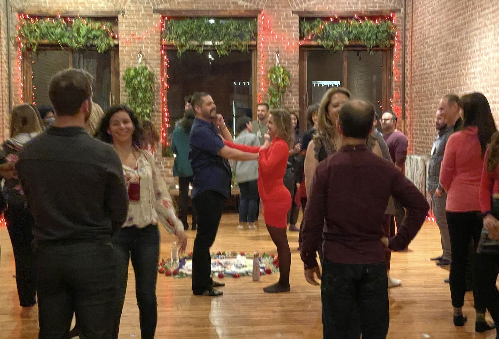 Facilitators demonstrating a guided connection exercise during a Tantra Speed Date event.
